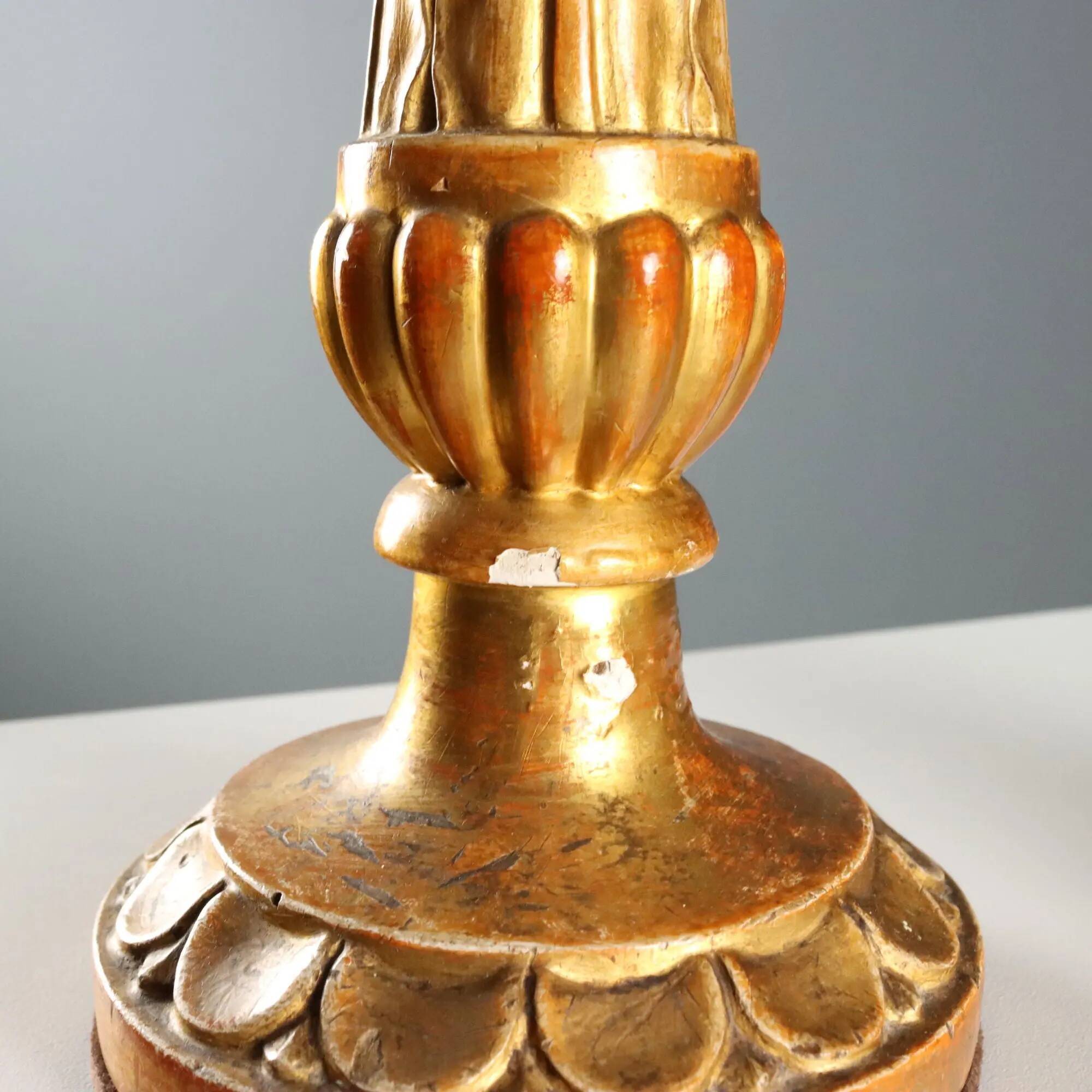 Pair of antique carved and gilded wooden candlesticks, Italy, 19th century.
