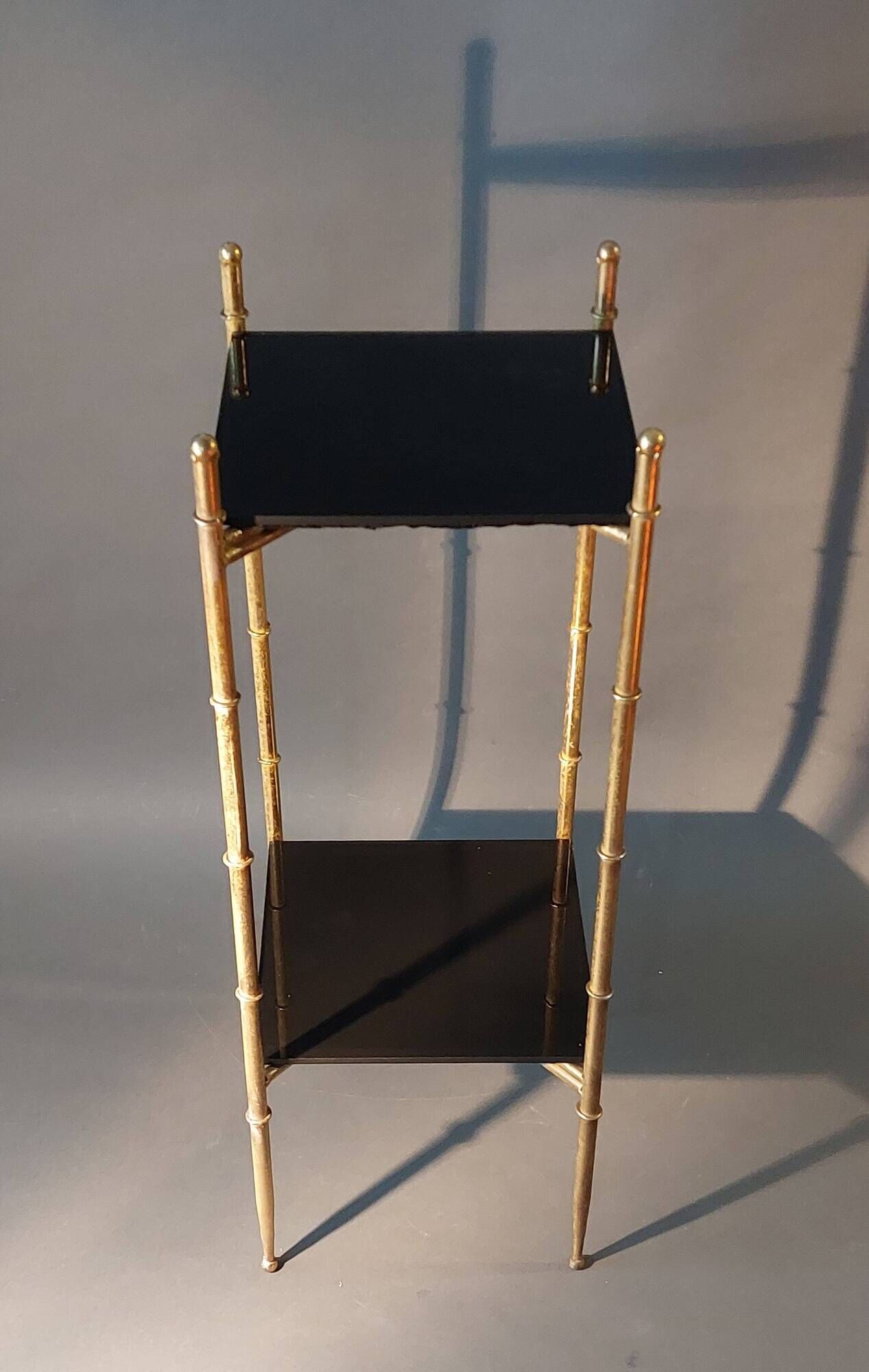 Pedestal table in patinated gilded brass faux foldable bamboo.