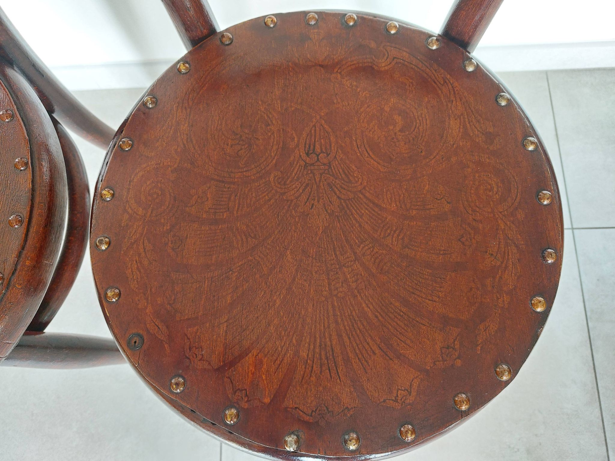 pair of round bistro chairs with a pattern on the seat, vintage