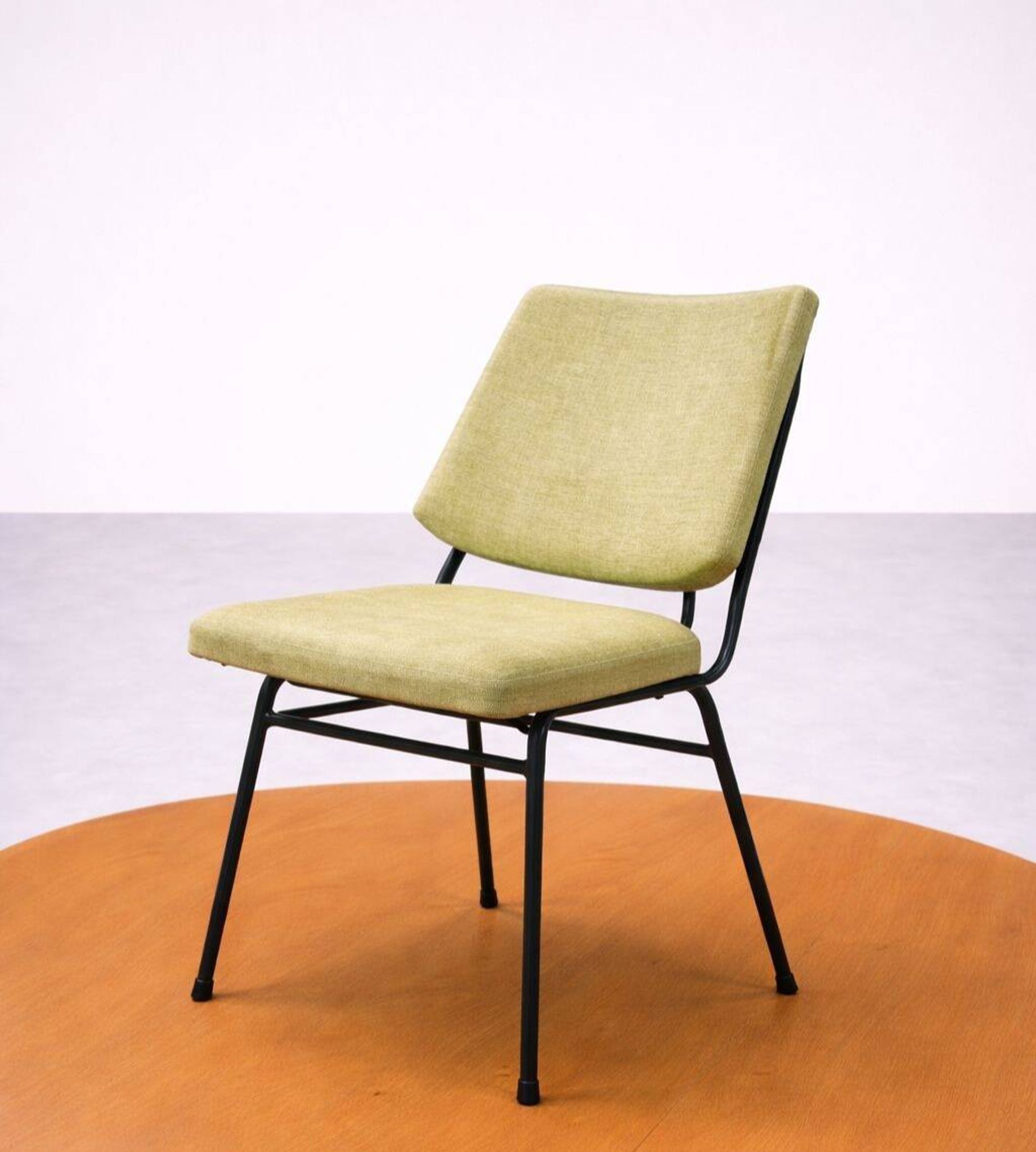 Vintage 1950s chair in black metal and almond green fabric.
