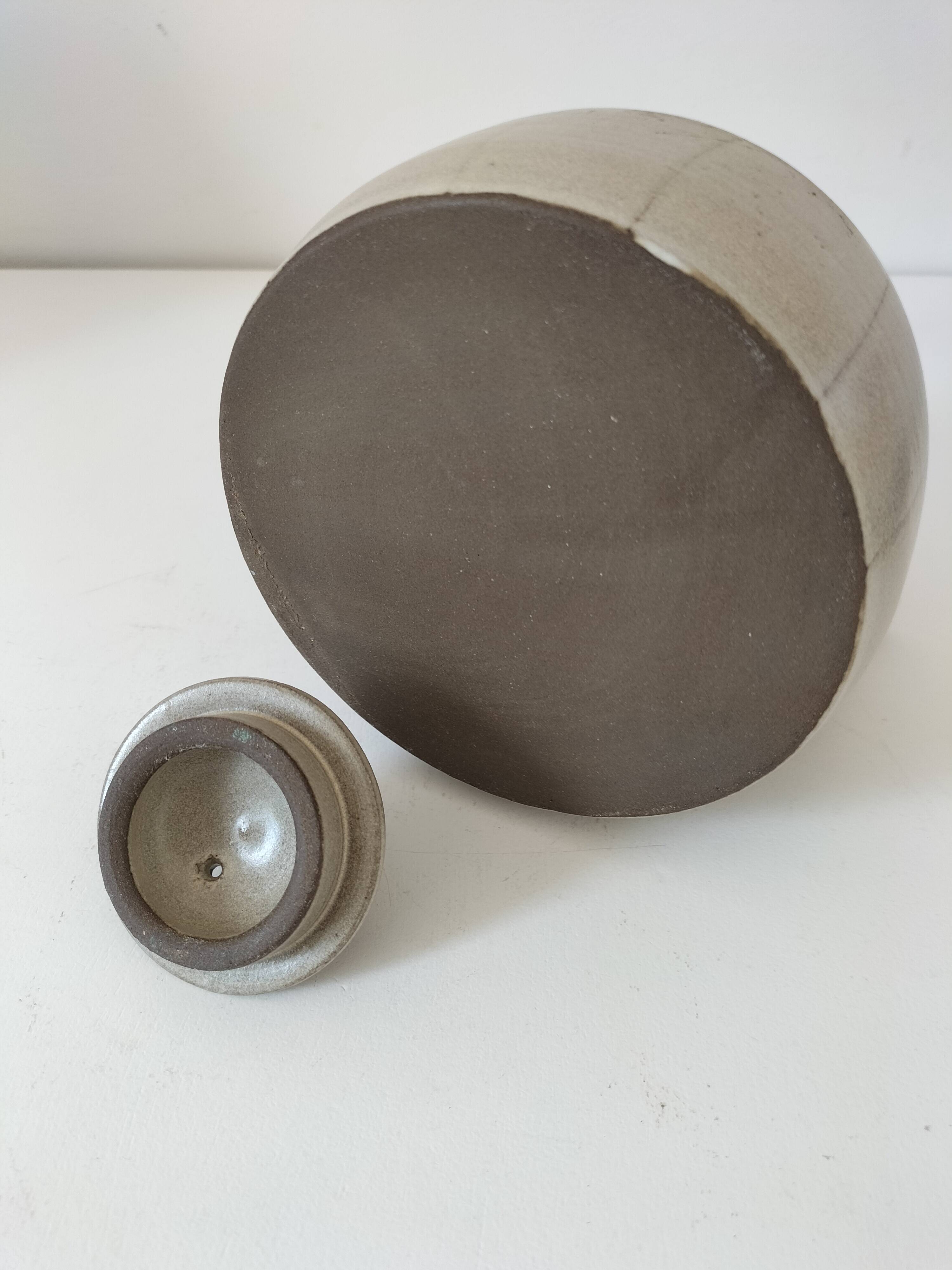 Beige stoneware teapot with stylized flowers and rattan handle