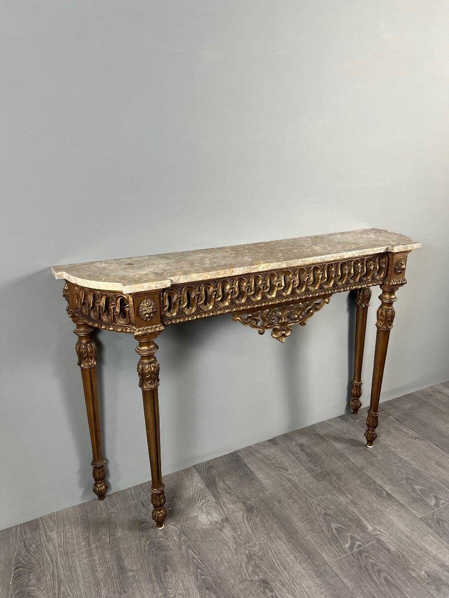 Louis XVI style console in carved wood with a gilded patina, 19th century.