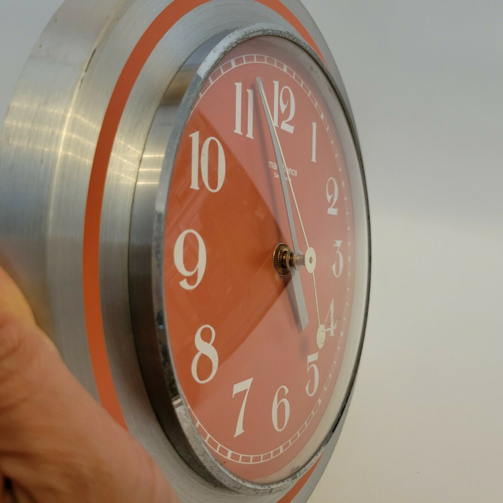 Old orange aluminum clock Manufrance Saint-Etienne