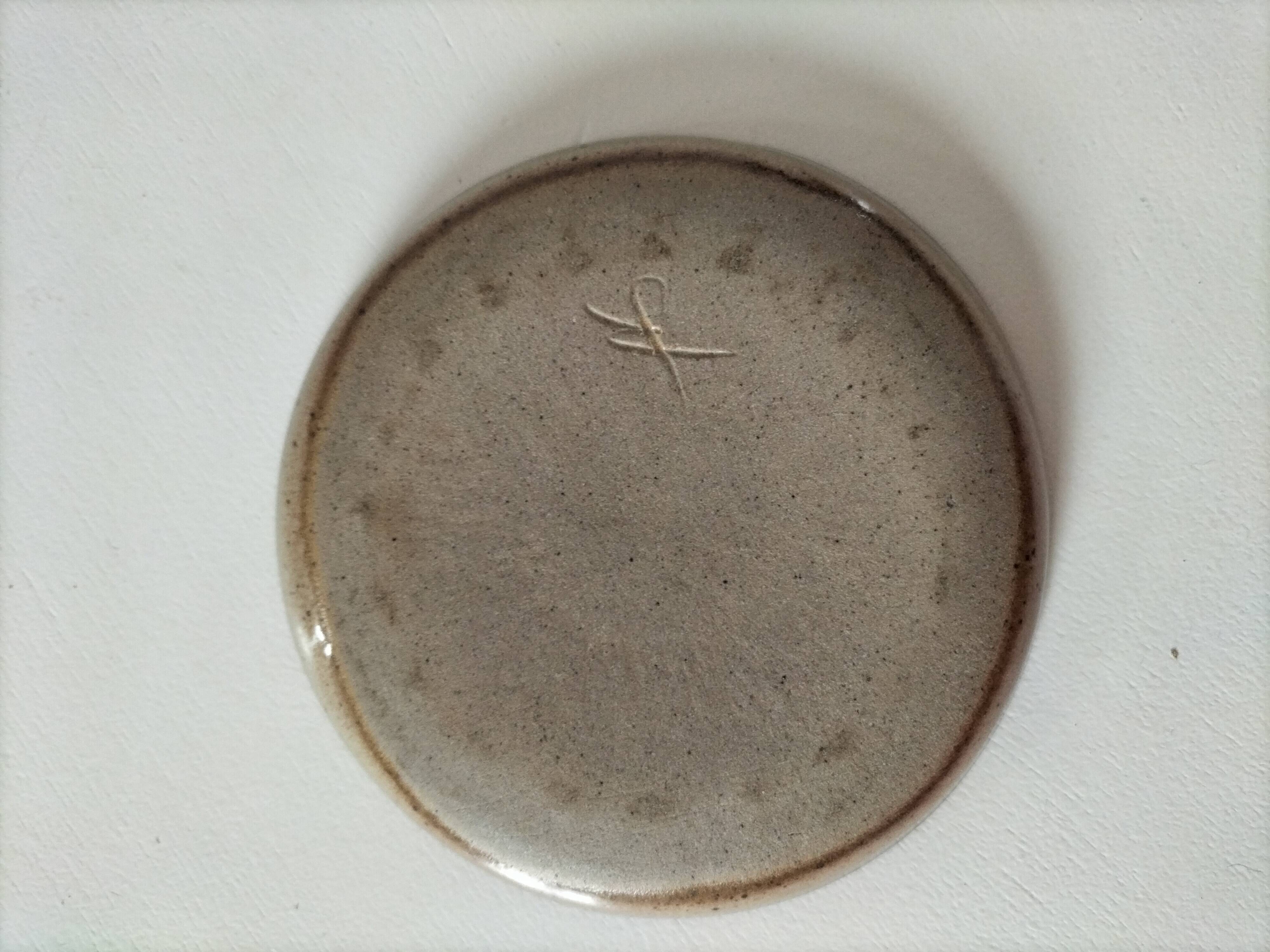 Signed stoneware bowl from Puisaye, relief decoration.