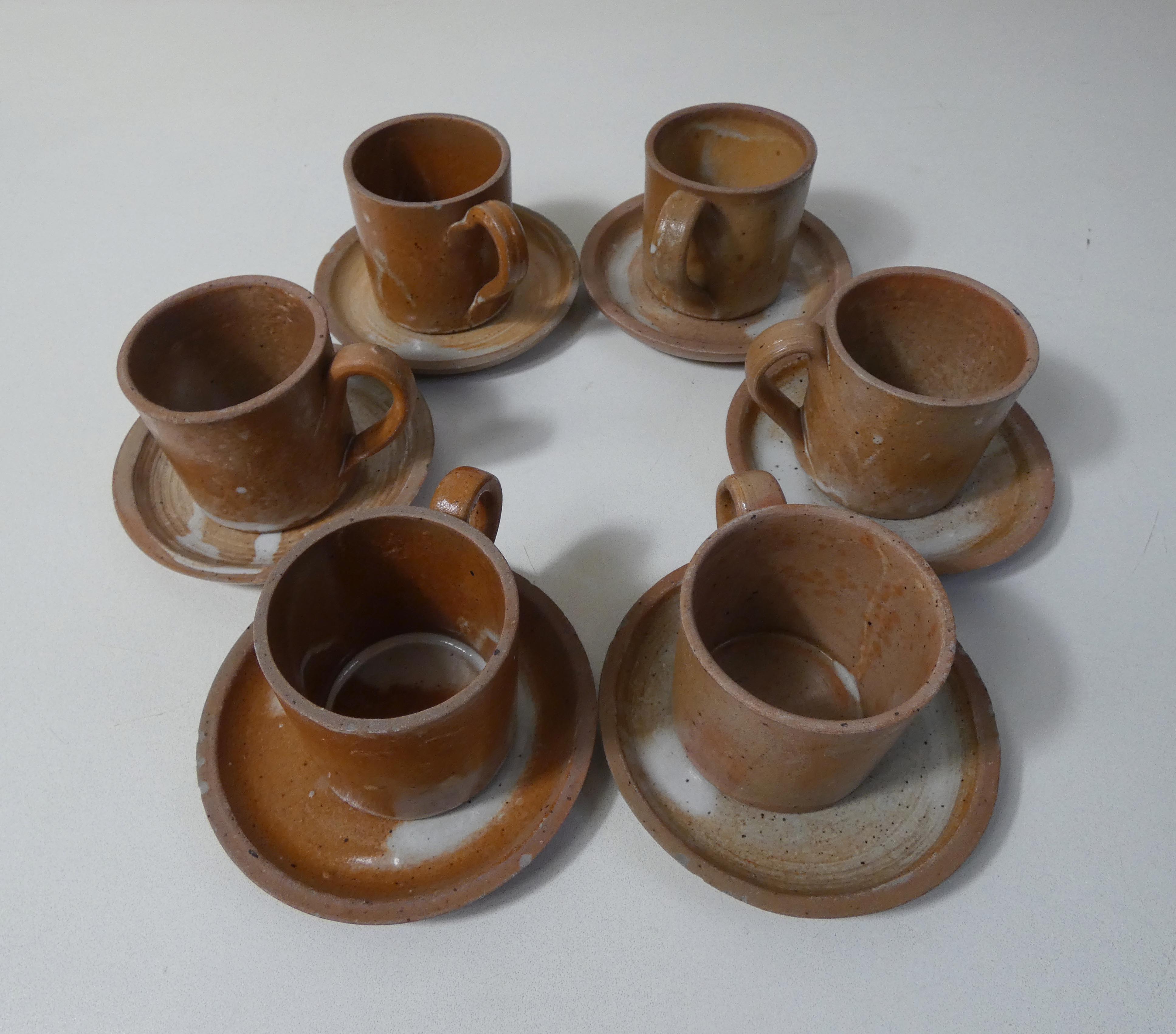 6 stoneware cups and saucers