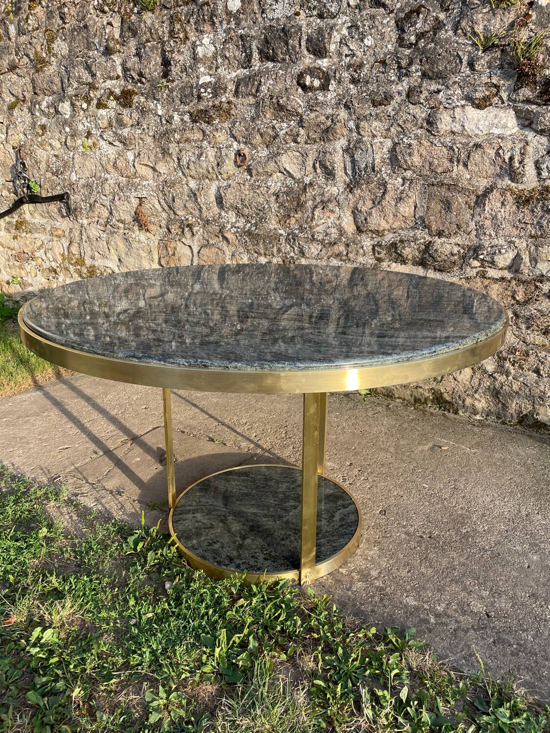 Round dining table with green marble and solid brass.