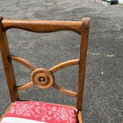 Pair of antique walnut chairs with rose design and red striped cushions.