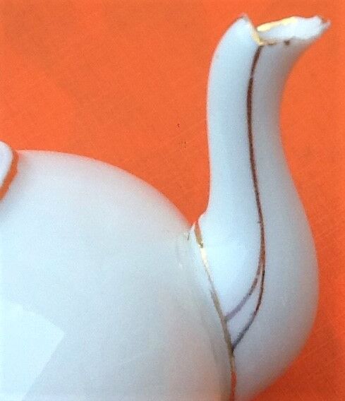 Old porcelain teapot with floral decoration