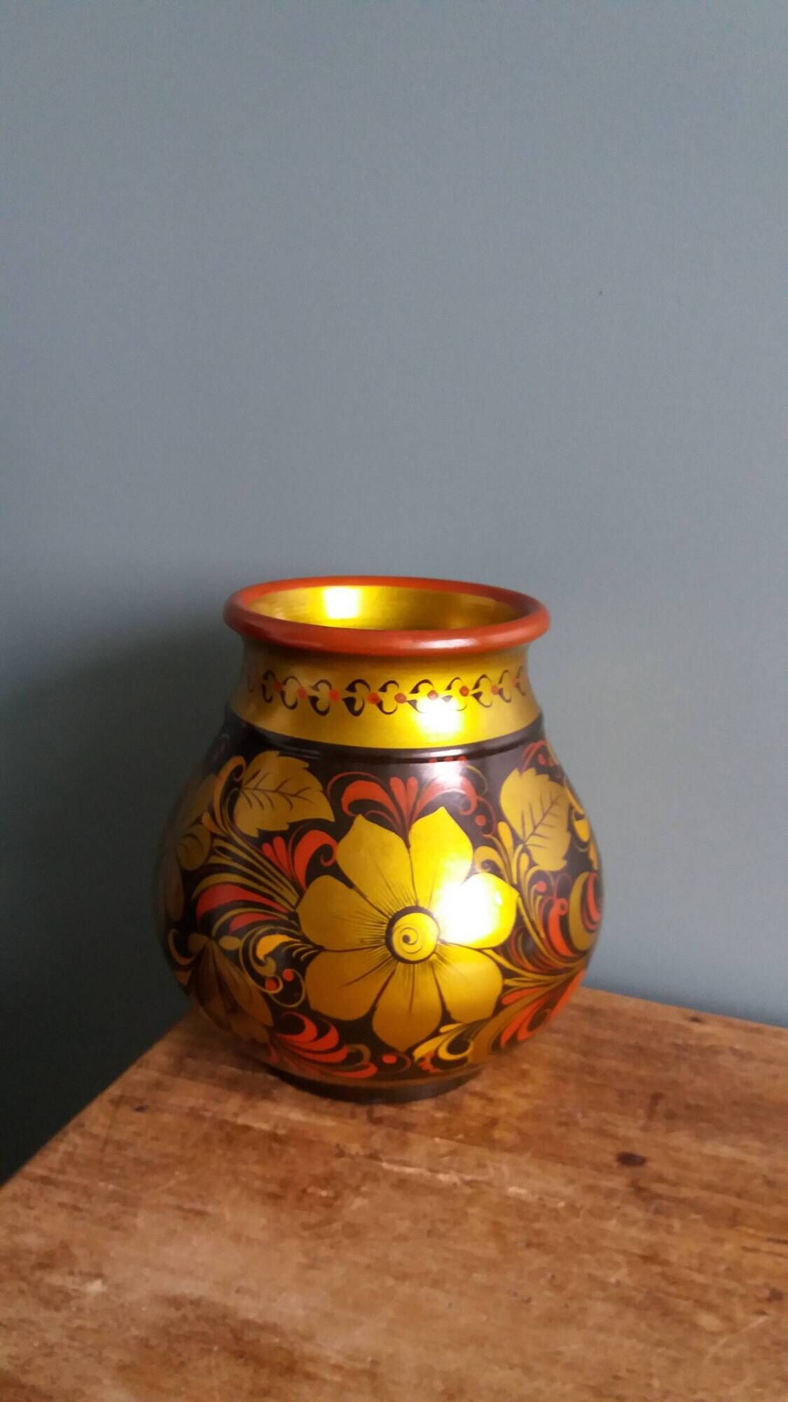 Khokhloma vase, Russian lacquered wood craftsmanship, hand-painted floral decoration.