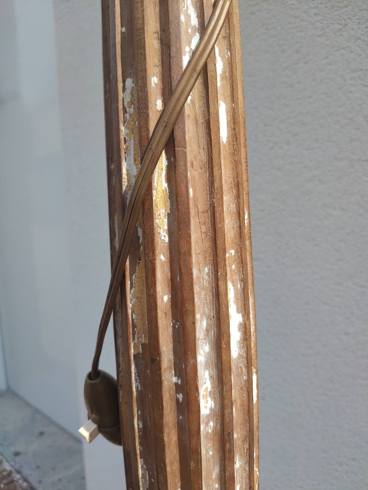 Large antique church candlestick in carved wood transformed into a lamp.