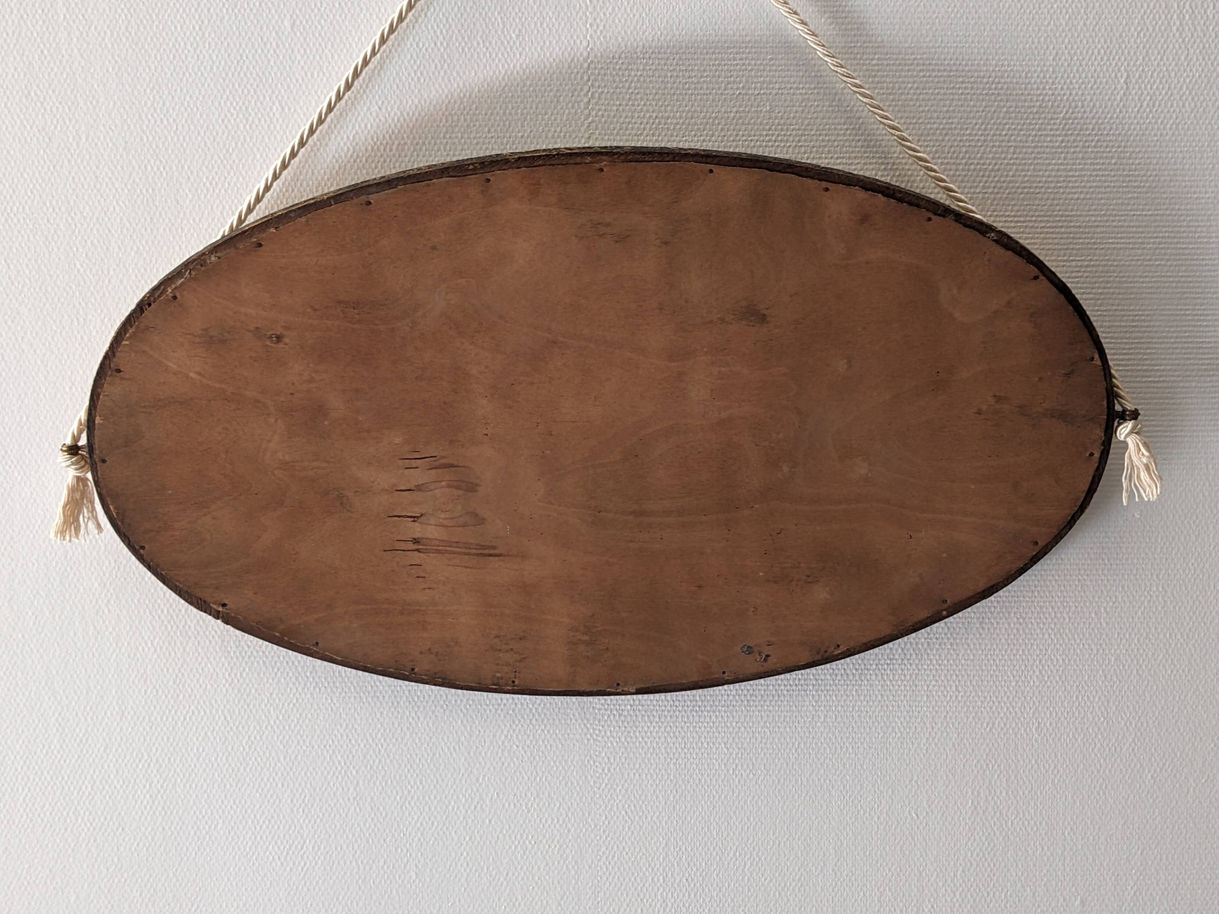 Art Deco oval mirror in gilded wood, France circa 1920