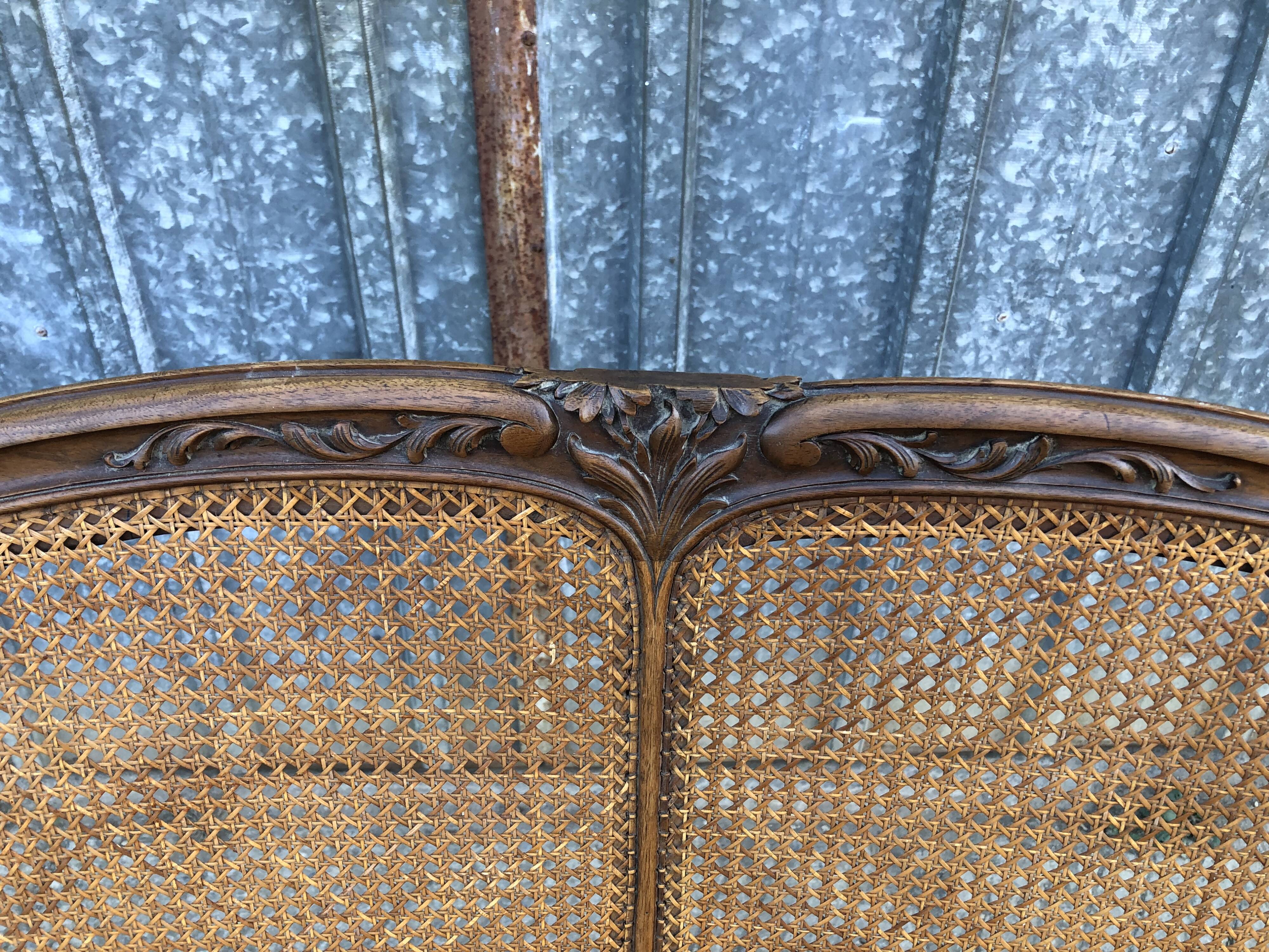 Antique Louis XV bench in solid walnut and caning