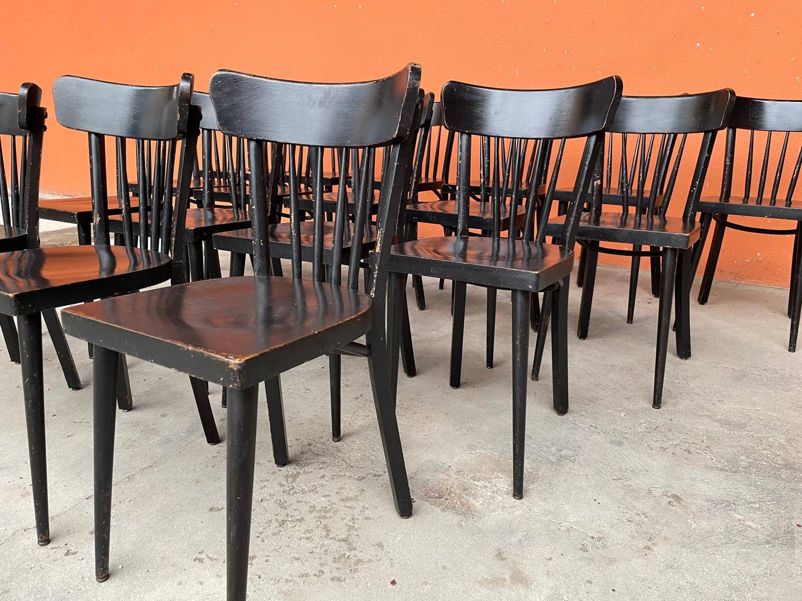Set of 18 curved wooden bistro chairs with patina from the 60s