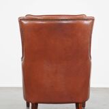 Cowhide armchair in good condition, finished with decorative nails