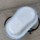 Antique bidet in enamelled sheet metal with wrought iron support