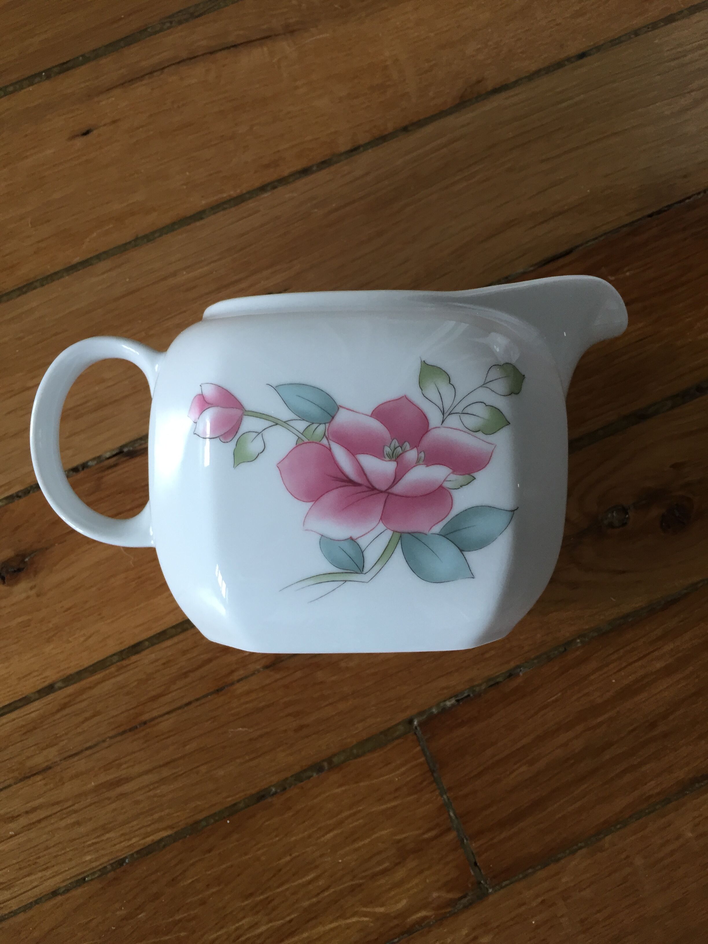 Vintage porcelain coffee or teapot with milk jug