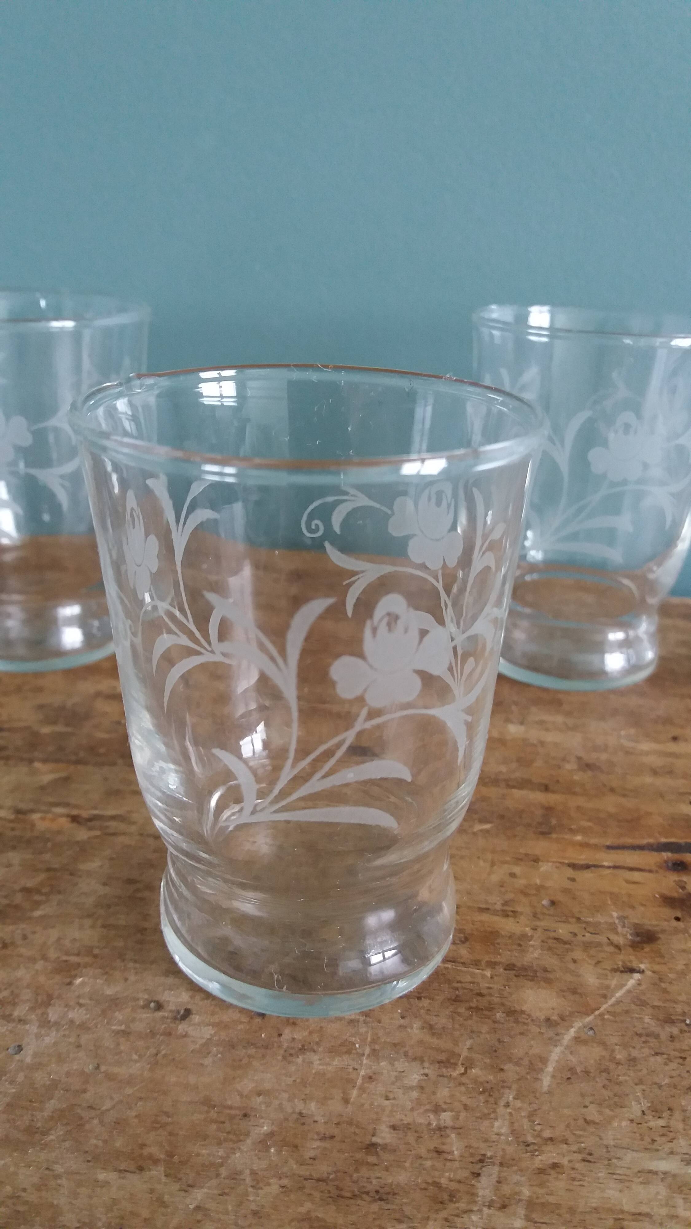 Old digestif or liqueur glasses, handcrafted glass with a floral pattern.