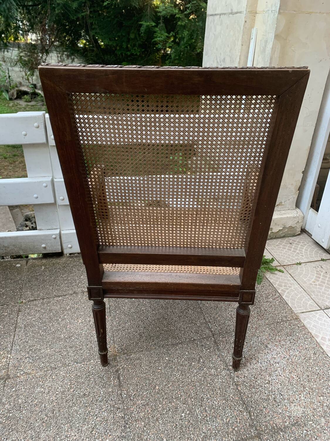 Wooden armchair with caning in Louis XVI style