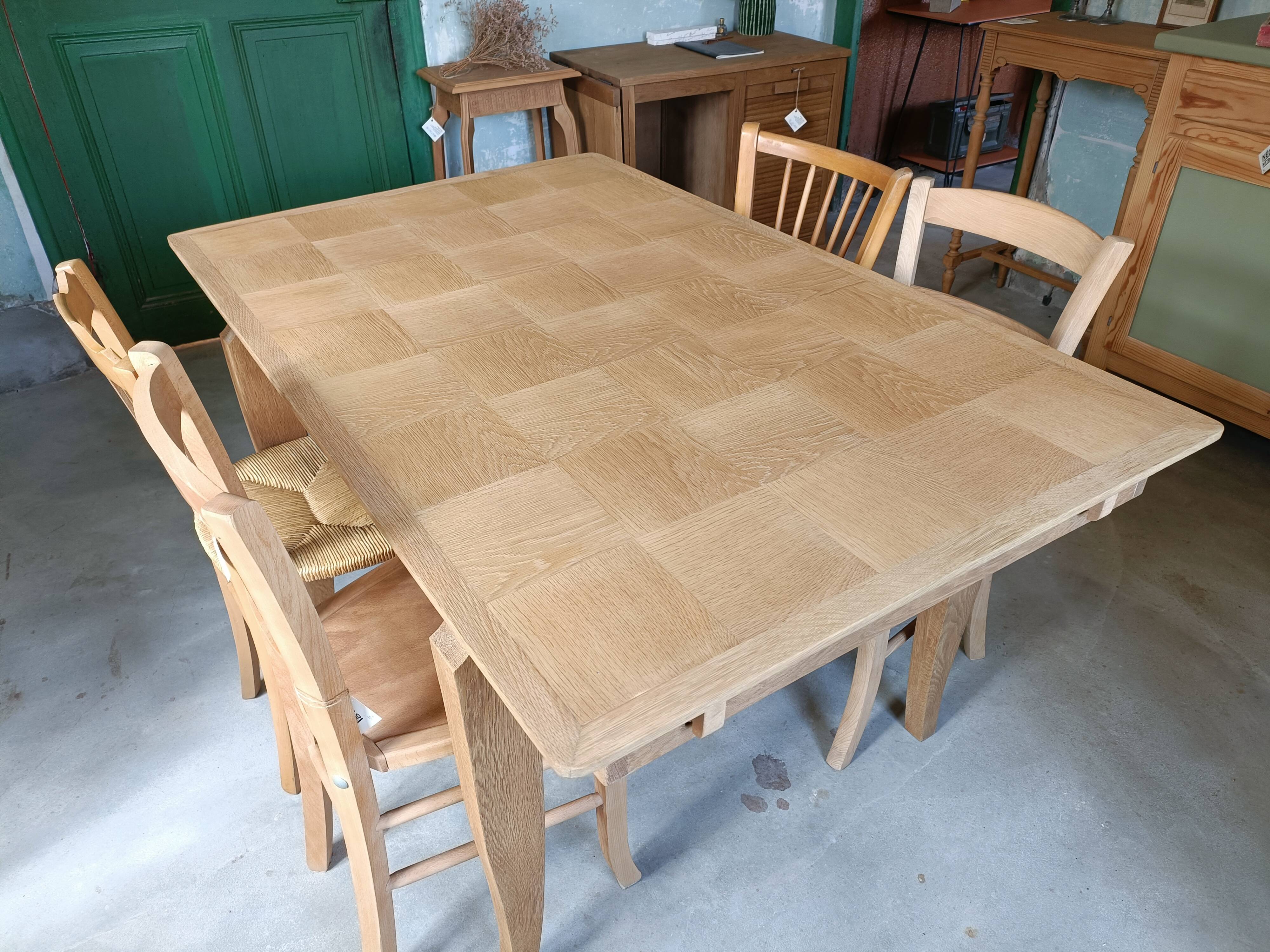 Oak dining table with a checkerboard top and extensions.