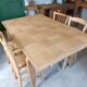 Oak dining table with a checkerboard top and extensions.