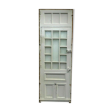 Service door with small tiles and 20th century glass impost