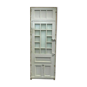Service door with small tiles and 20th century glass impost