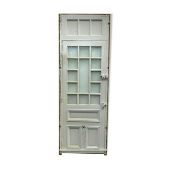 Service door with small tiles and 20th century glass impost