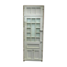 Service door with small tiles and 20th century glass impost