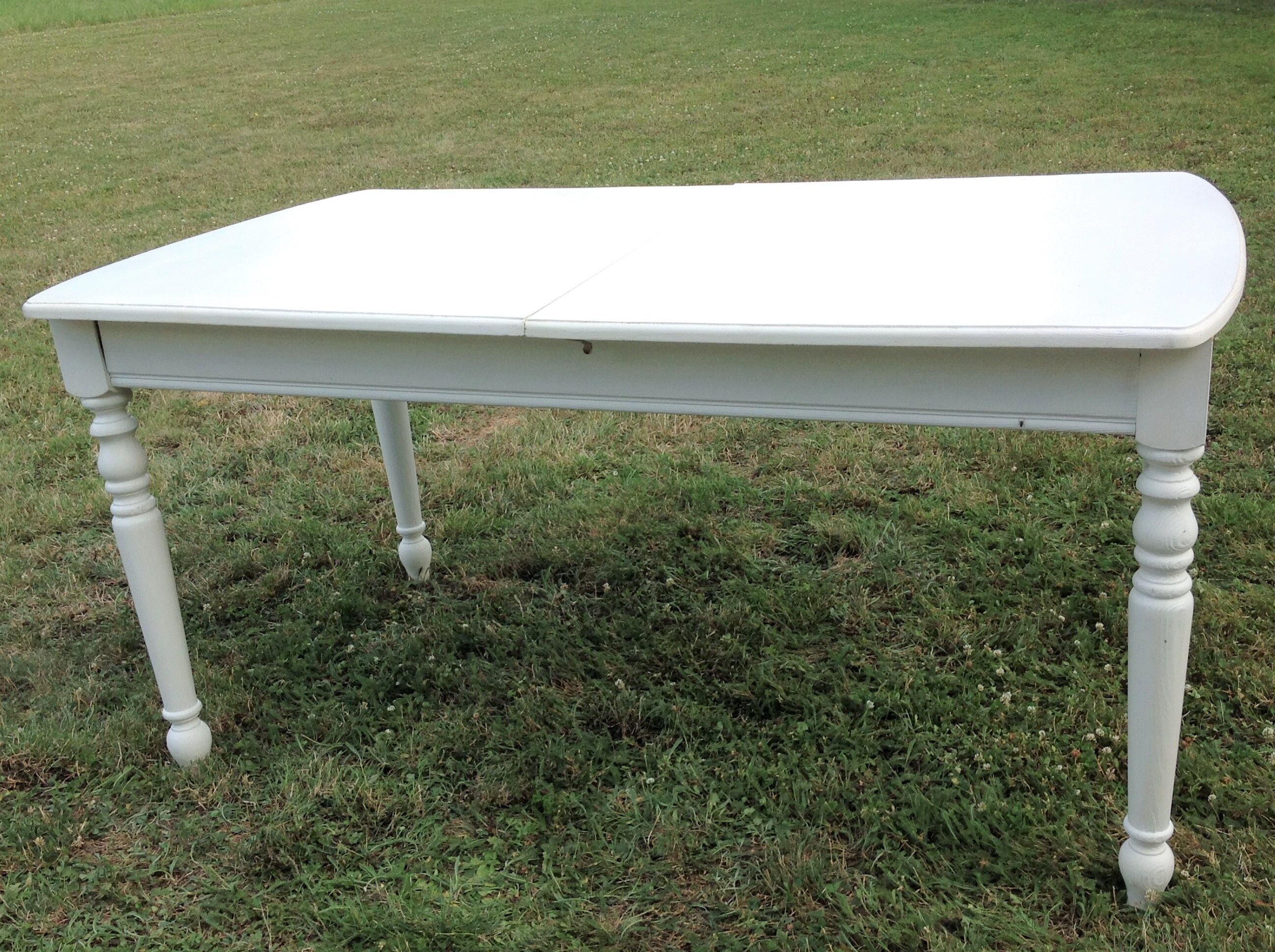 White farmhouse table set and four chairs