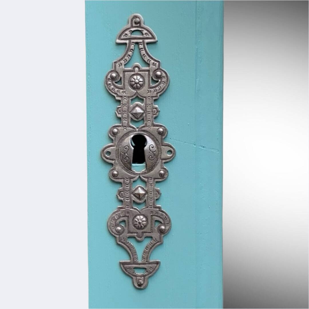 Beveled mirror on turquoise Parisian door