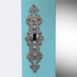Beveled mirror on turquoise Parisian door