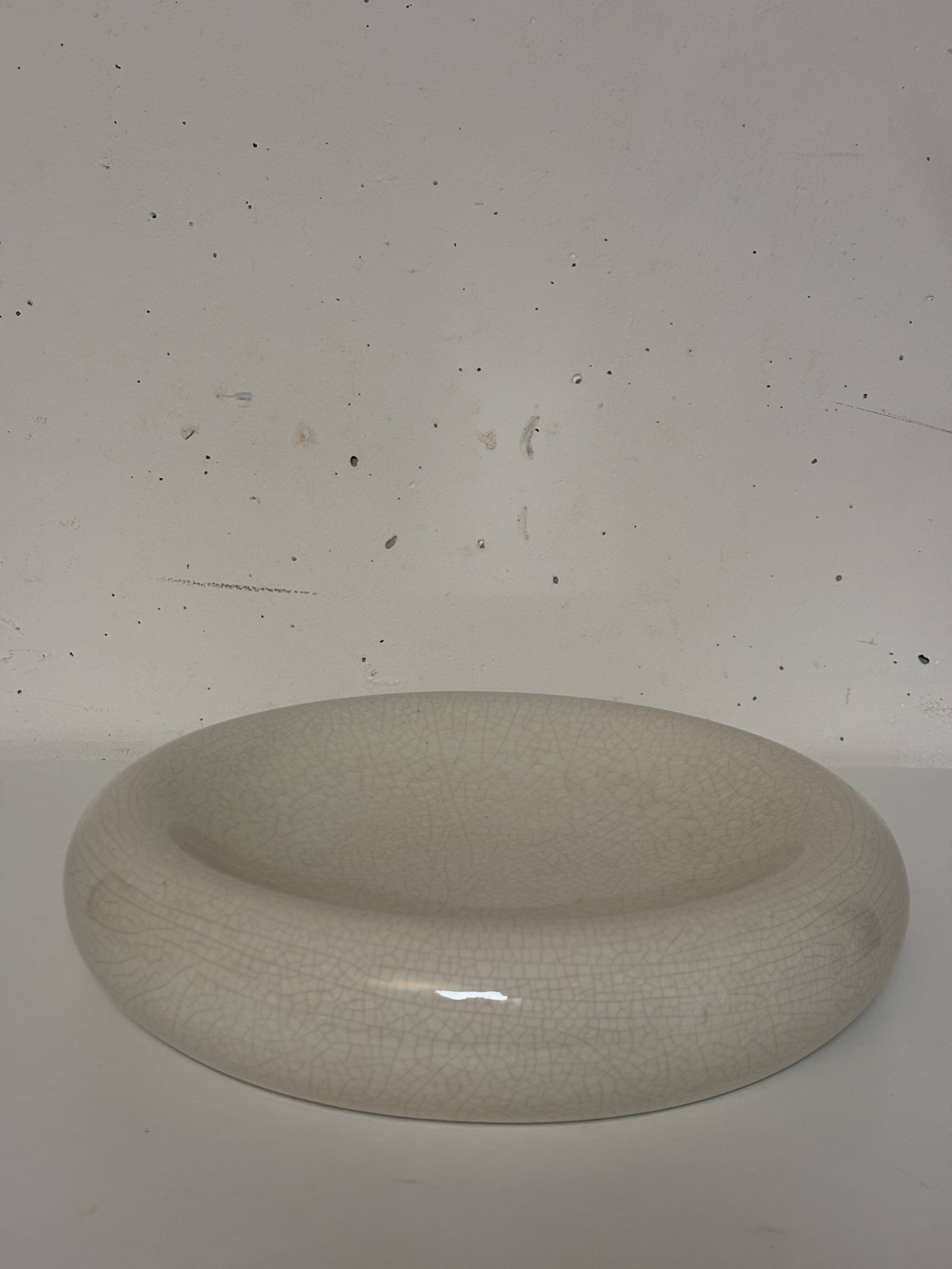 Empty pocket, cracked ceramic dish 1980