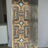 Indonesian construction element in carved wood with cross pattern in red, white geometric frieze