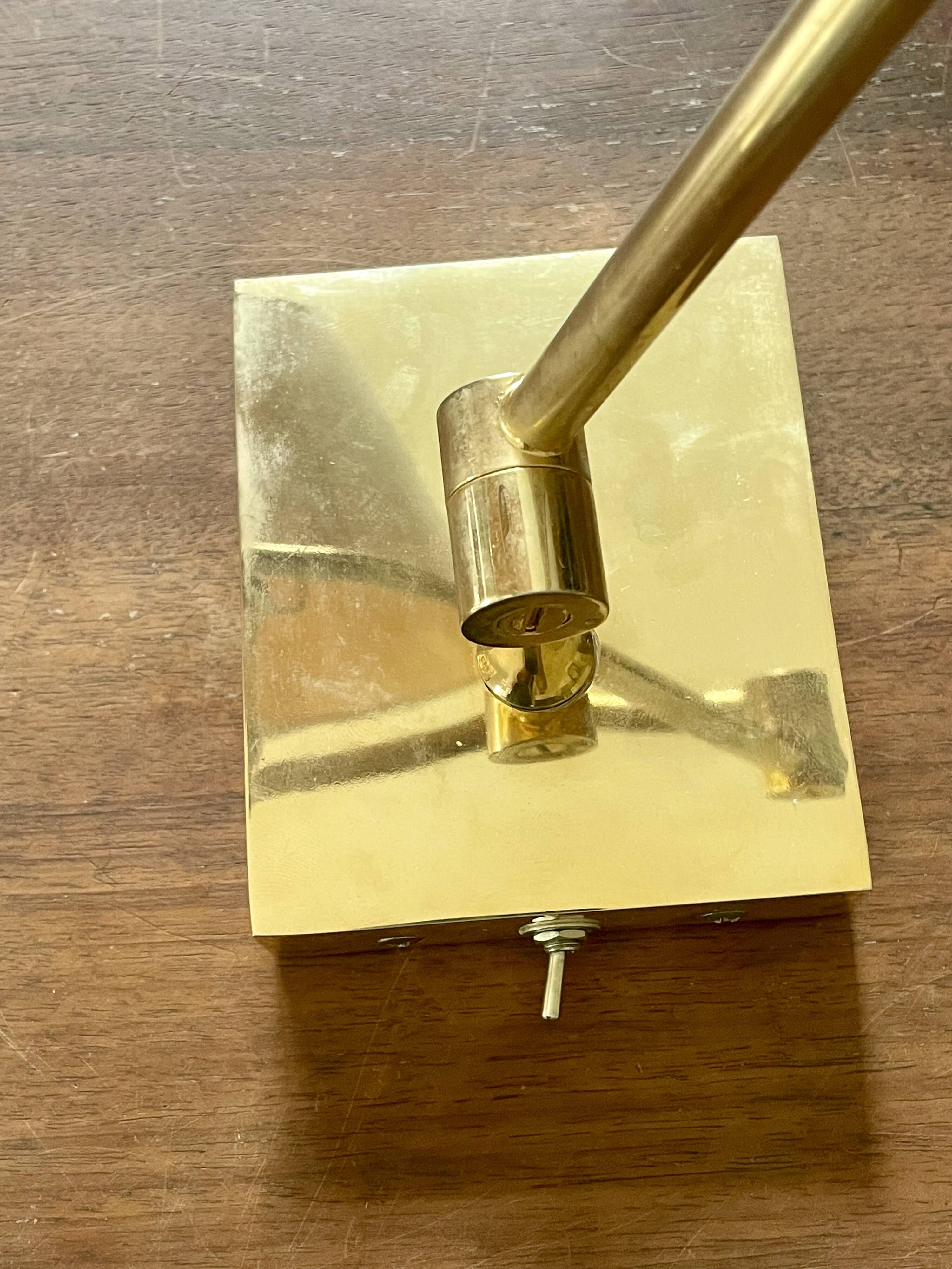 Pair of vintage brass wall lights with adjustable arms.