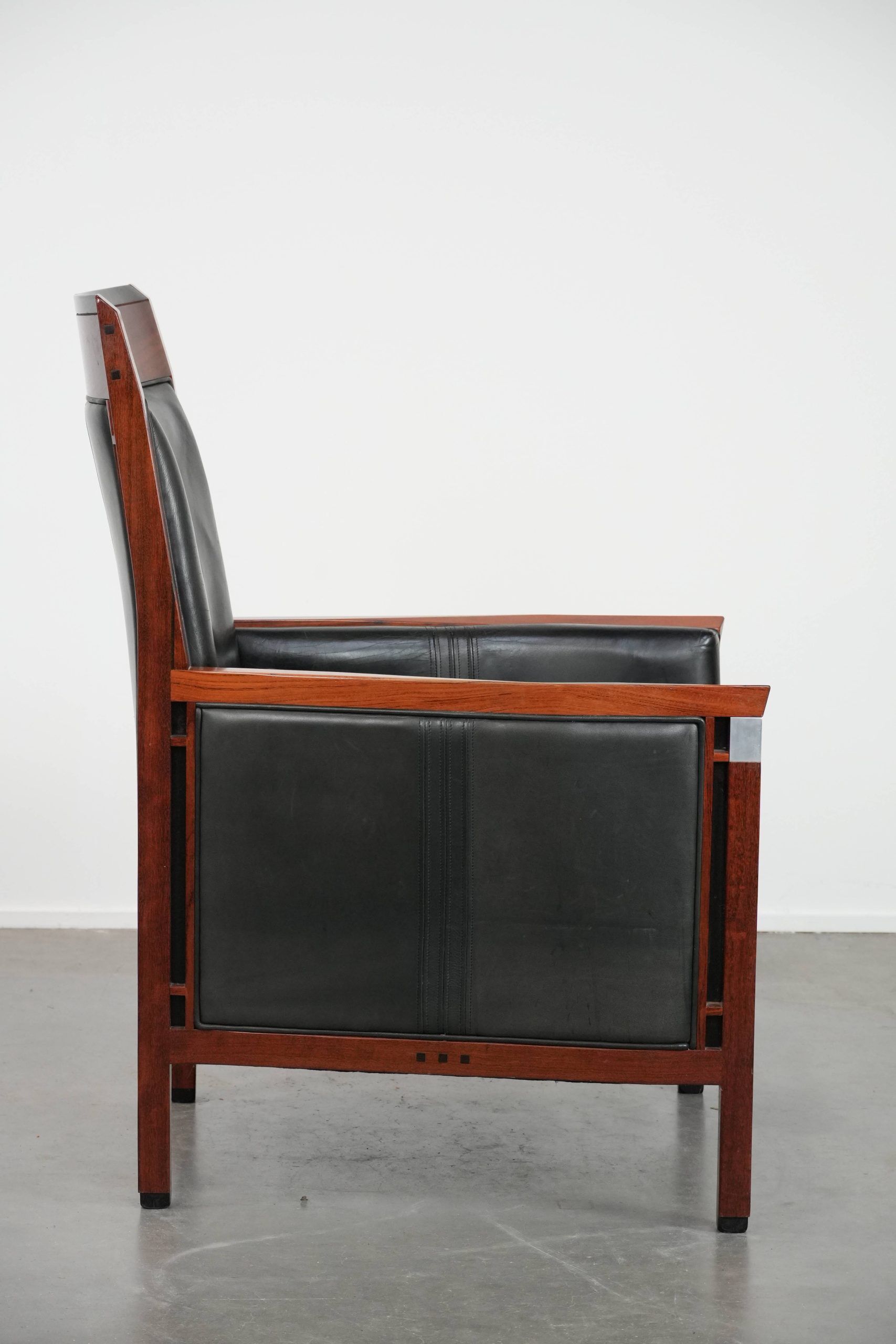 Black cowhide leather and wooden Art Deco design armchair