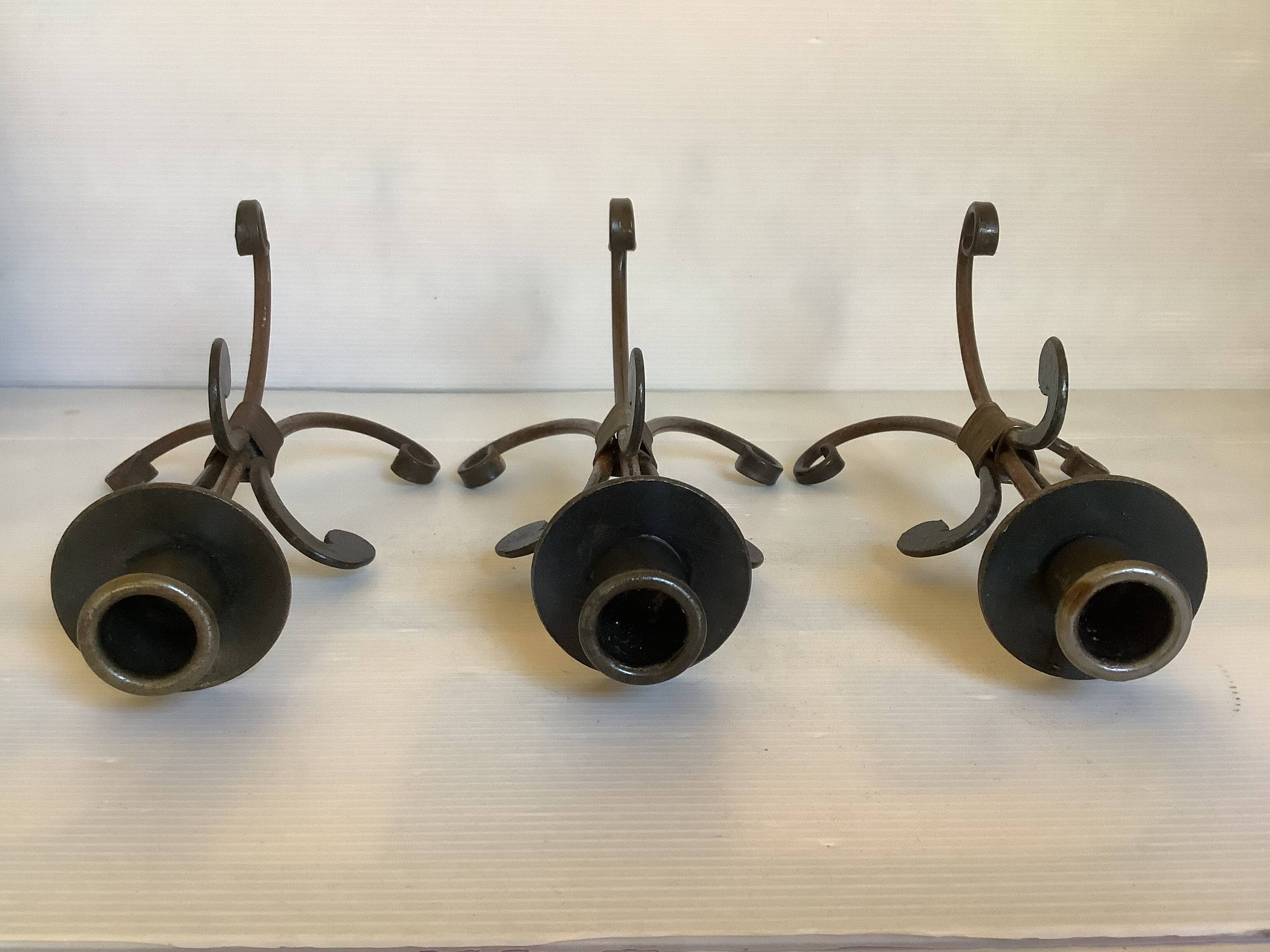 Trio of wrought iron candlesticks