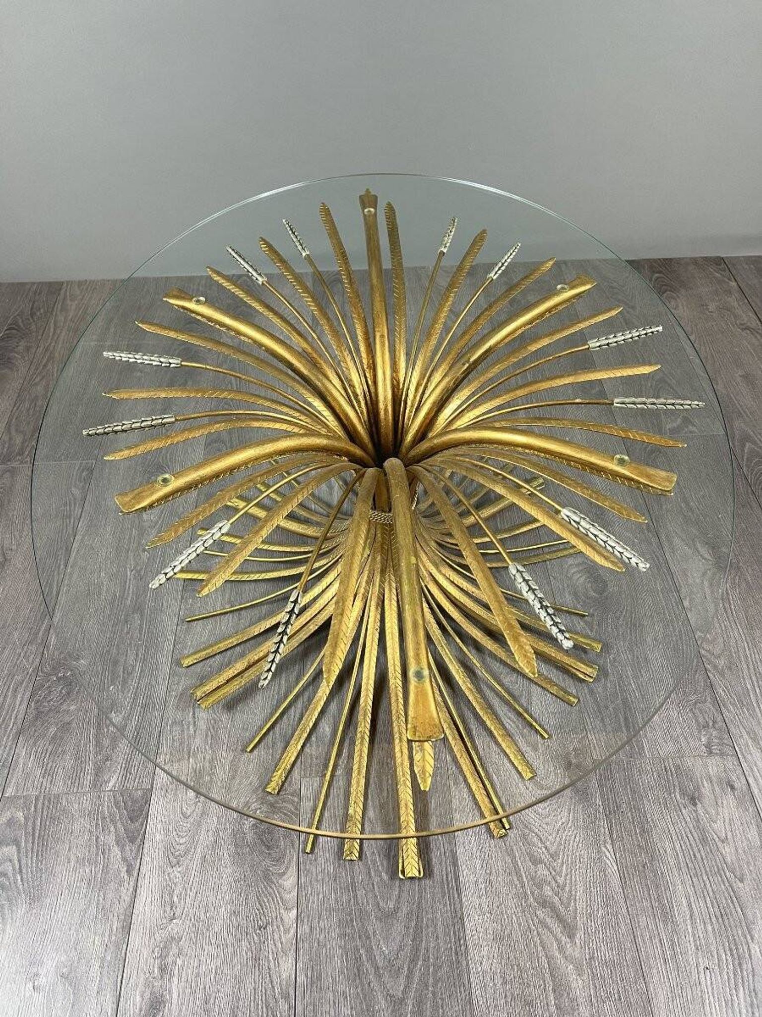 Gold metal and glass coffee table, 20th century, in the style of Robert Goos.