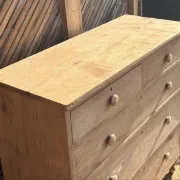 Large antique English chest of drawers in raw solid oak.