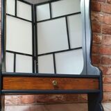 A renovated mirror in a wooden frame with a drawer and a shelf