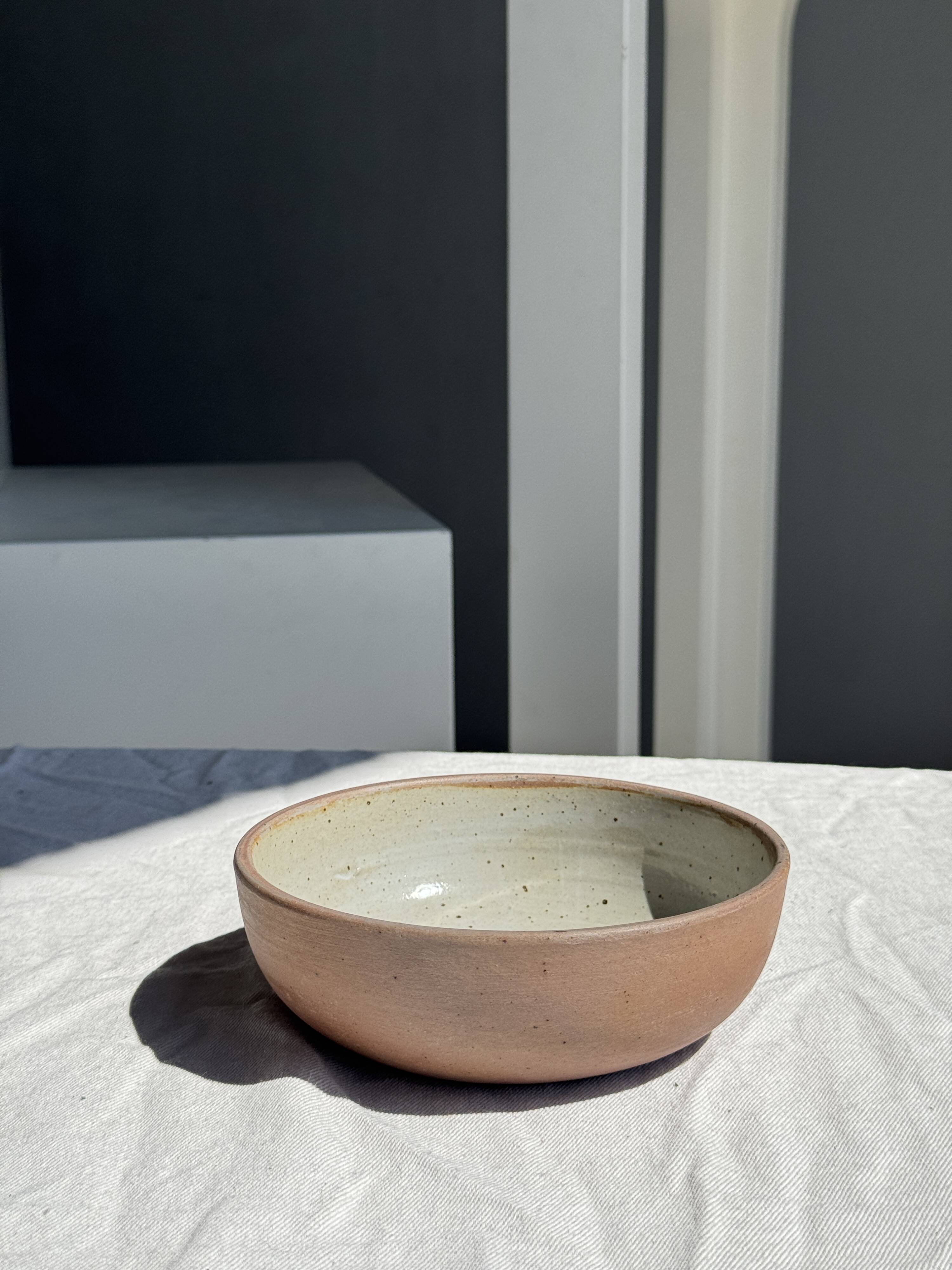 A speckled grey interior bowl with a matte brown exterior H5 D15
