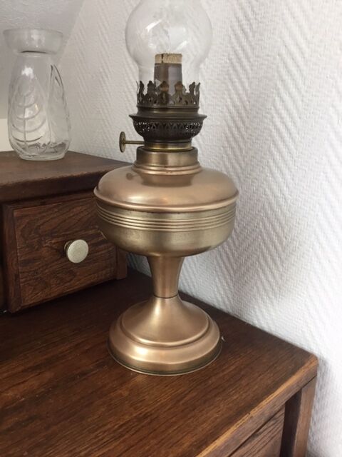Old oil lamp on pink copper stand