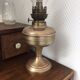 Old oil lamp on pink copper stand