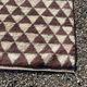Very large Moroccan Berber rug in cream and burgundy 450x300 cm with a triangular pattern.