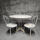 Antique painted wrought iron garden furniture, round table and four chairs.