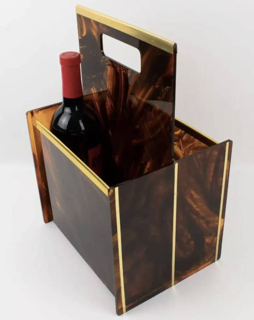 Tortoiseshell lucite magazine rack from the Christian Dior Home collection.