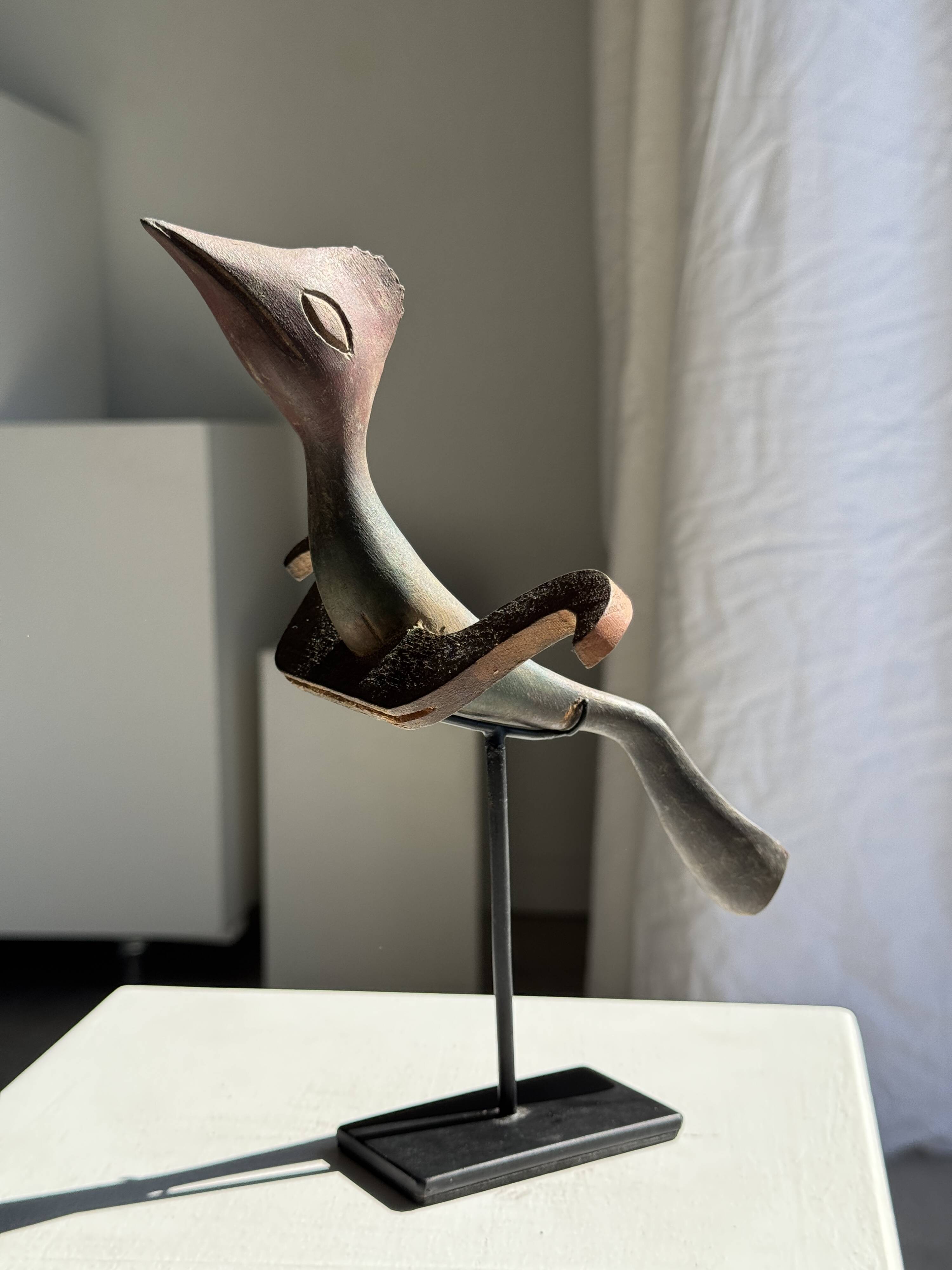 Traditional Indonesian decorative wooden bird on a base, crest model.