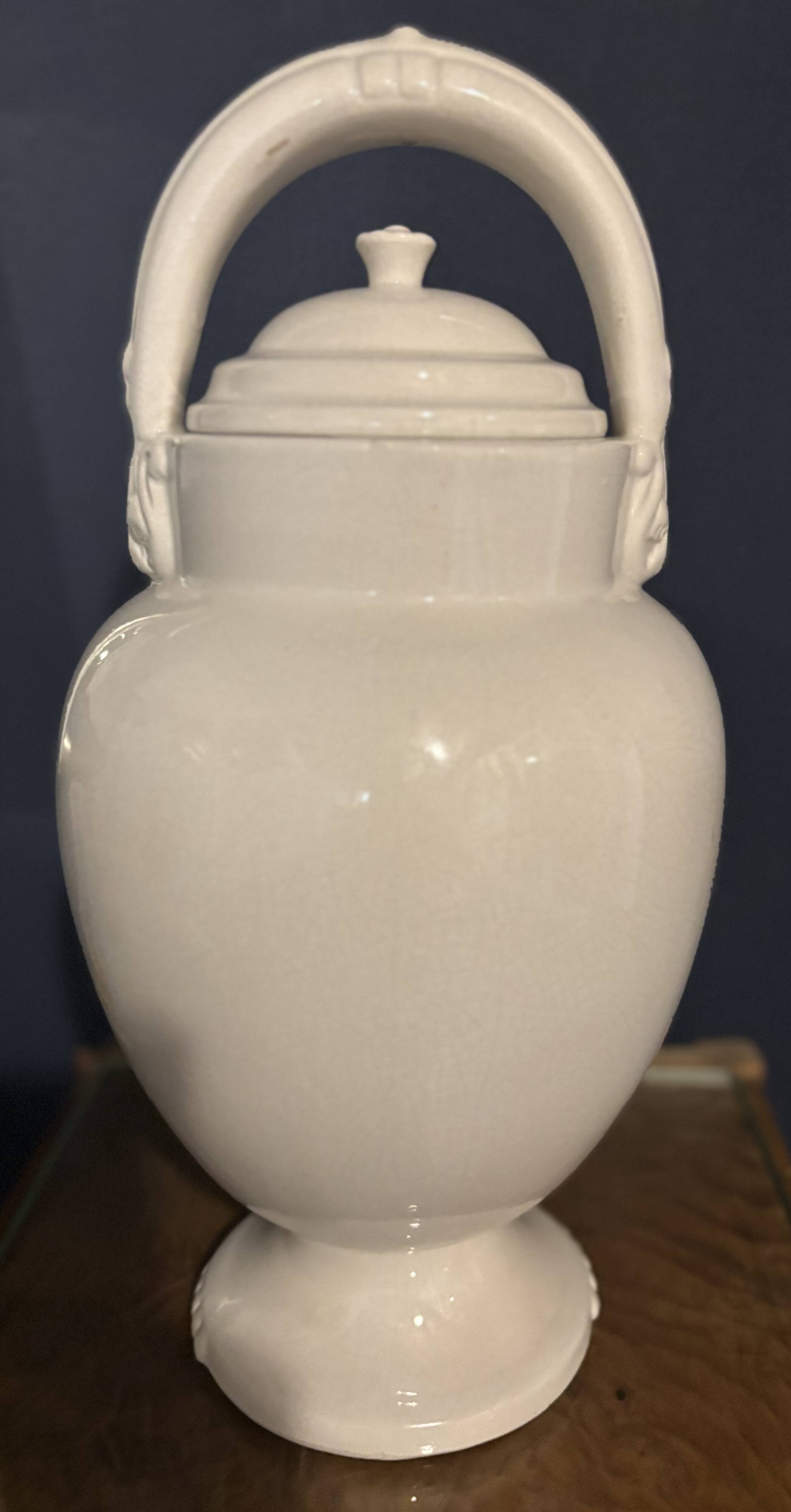 Large white faience jug with a satyr head spout, 19th century.