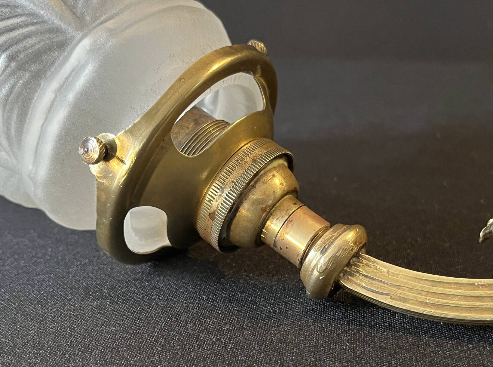 20th century Louis XVI style swan neck wall light in arabesque bronze and pleated glass tulip.