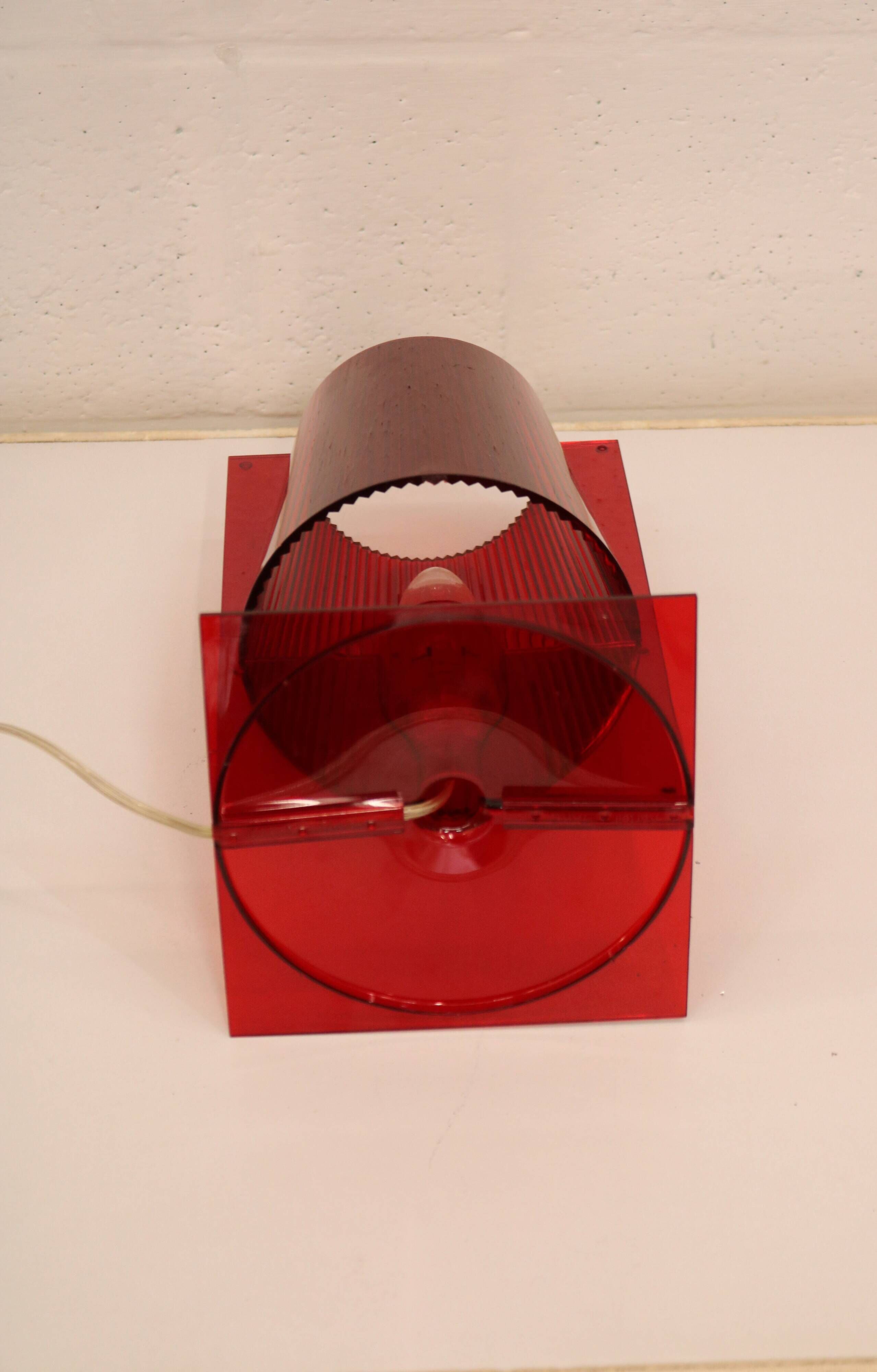 Red plastic Kartell table lamp - model Take - design by Ferruccio Laviani