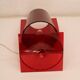 Red plastic Kartell table lamp - model Take - design by Ferruccio Laviani